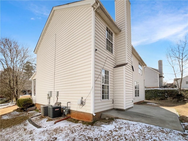 view of snowy exterior with a patio