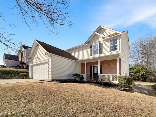 view of property featuring a garage, a porch, and a front lawn