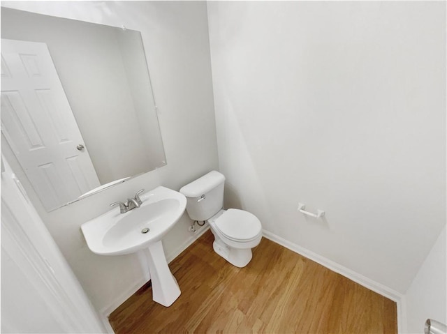 bathroom with toilet and hardwood / wood-style flooring