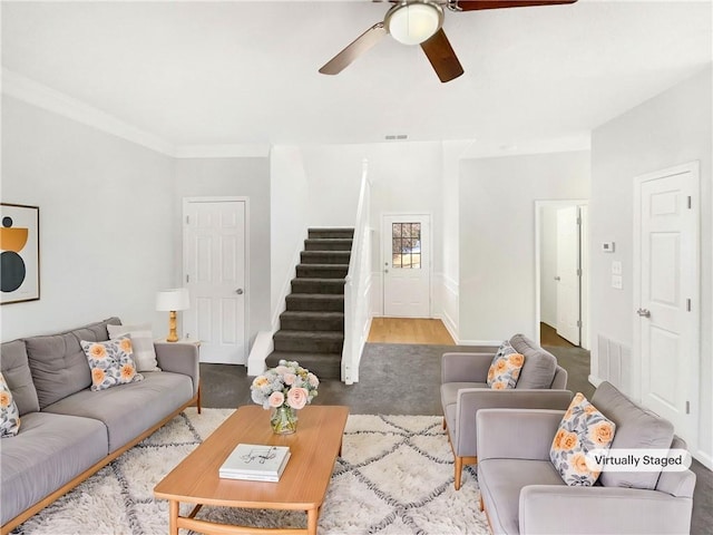 living room with ceiling fan and crown molding