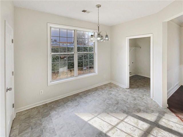 unfurnished dining area featuring an inviting chandelier