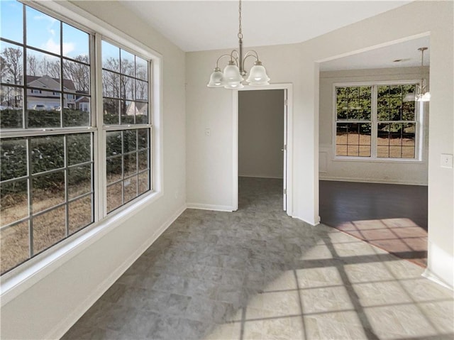 unfurnished dining area with a chandelier