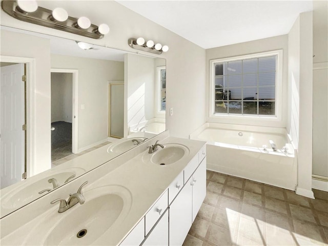 bathroom with a bath and vanity