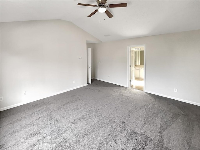 carpeted spare room featuring lofted ceiling and ceiling fan