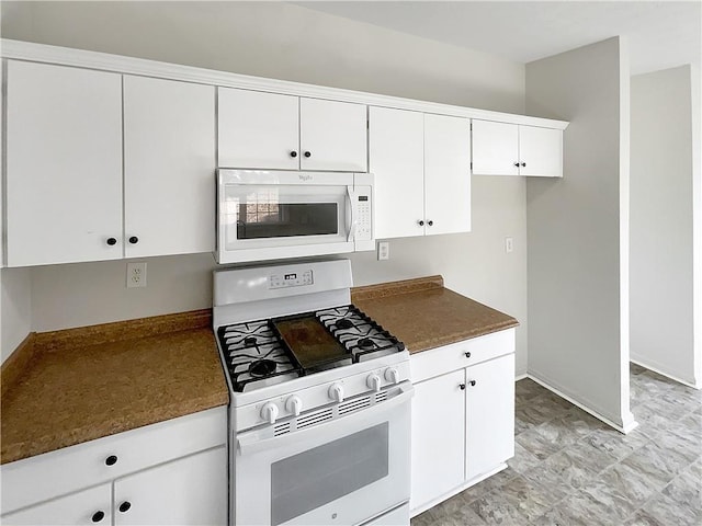 kitchen with white appliances and white cabinets