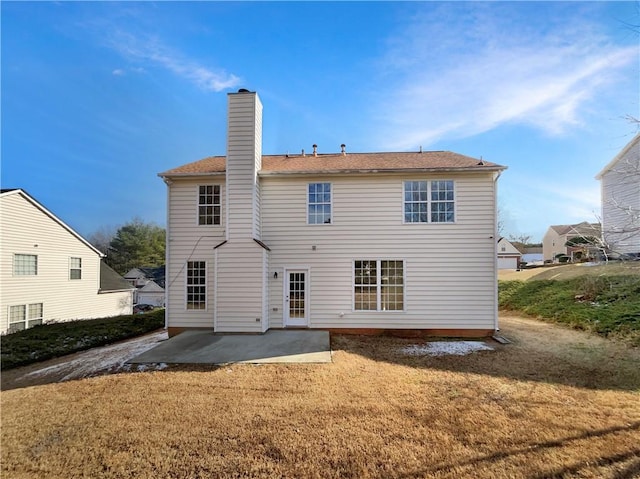 rear view of house featuring a patio area and a lawn