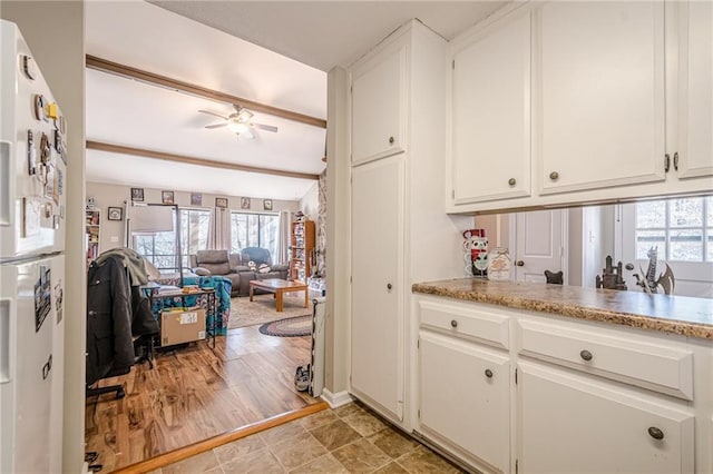 200 Villa Rd Unit 103, Jasper, GA 30143 - kitchen with freestanding refrigerator, white cabinets, ceiling fan, beamed ceiling, and light countertops