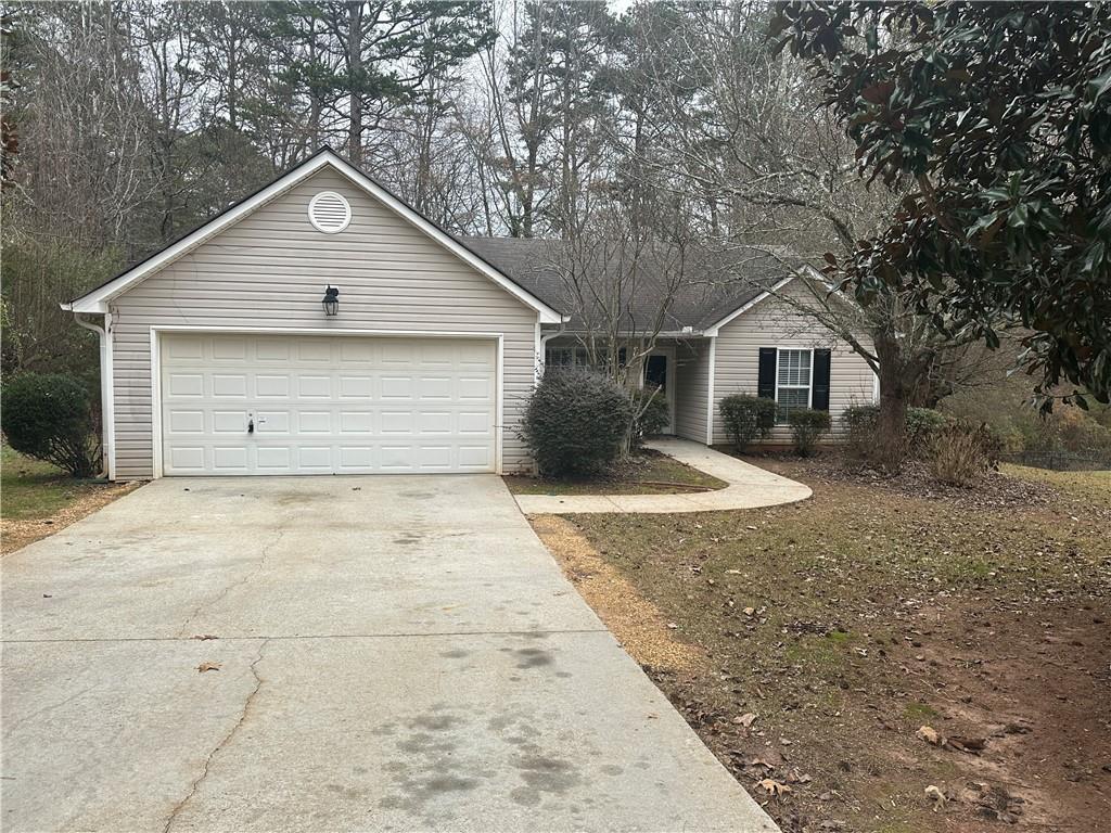 ranch-style house featuring a garage