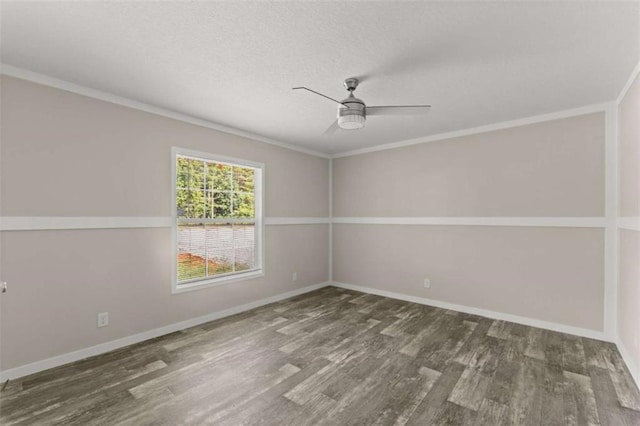 spare room with ceiling fan, crown molding, and dark wood-type flooring