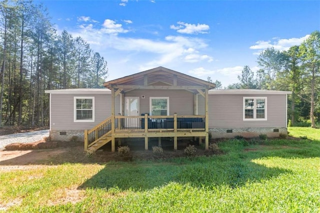 back of house with a lawn and a wooden deck