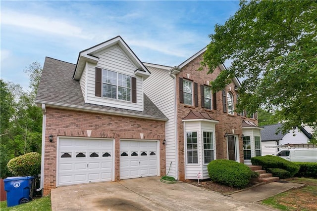 colonial inspired home with a garage, brick siding, concrete driveway, and a shingled roof