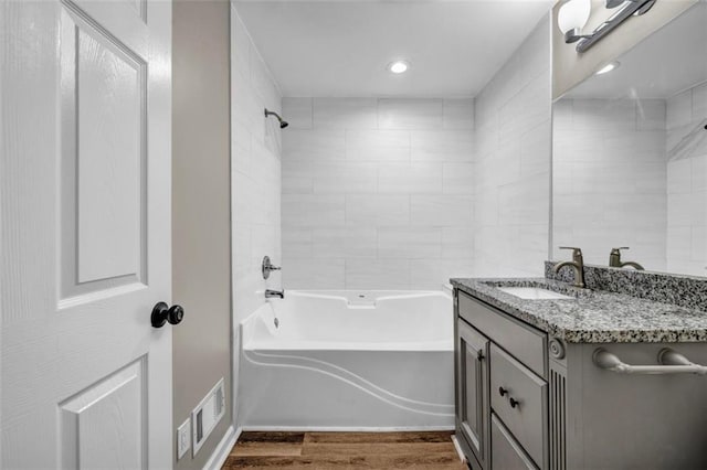 3927 Airline Rd, Mcdonough, GA 30252 - full bath featuring vanity, wood finished floors, washtub / shower combination, and recessed lighting