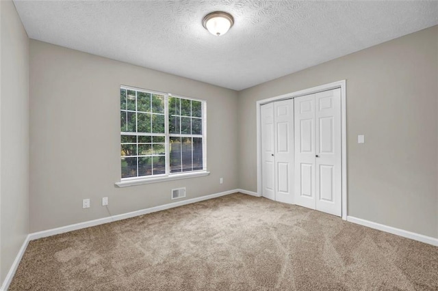 3927 Airline Rd, Mcdonough, GA 30252 - unfurnished bedroom with carpet, a closet, baseboards, and a textured ceiling