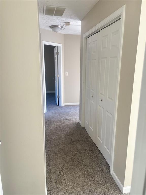 hallway with carpet floors