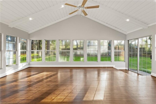 unfurnished sunroom with ceiling fan, a healthy amount of sunlight, and beam ceiling