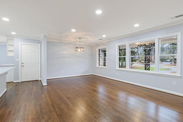 unfurnished living room featuring crown molding and dark hardwood / wood-style floors