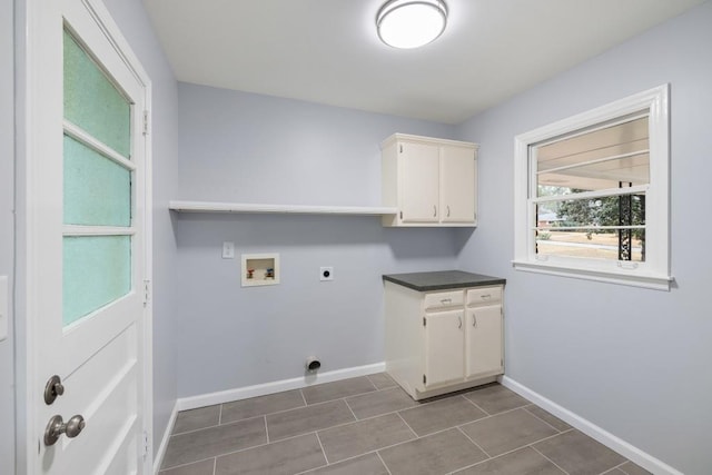 clothes washing area featuring hookup for a washing machine, hookup for an electric dryer, and cabinets