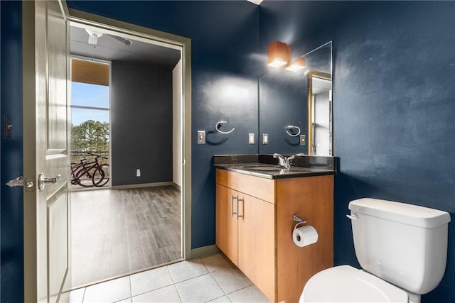 bathroom featuring vanity, tile patterned floors, and toilet