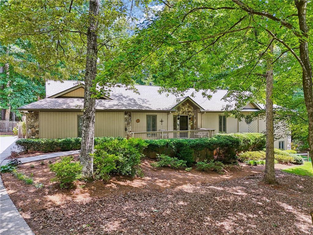 211 Black Kettle Ln, Johns Creek, GA 30022 - ranch-style home featuring stone siding and fence