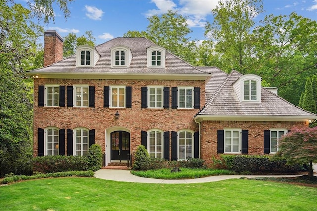 4555 Peachtree Dunwoody Rd, Sandy Springs, GA 30342 - colonial inspired home with brick siding, a chimney, and a front yard