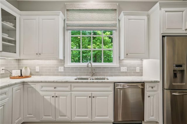 4555 Peachtree Dunwoody Rd, Sandy Springs, GA 30342 - kitchen featuring glass insert cabinets, white cabinets, tasteful backsplash, a sink, and stainless steel appliances