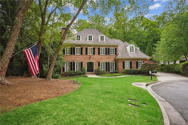 4555 Peachtree Dunwoody Rd, Sandy Springs, GA 30342 - colonial inspired home with brick siding, a chimney, and a front yard