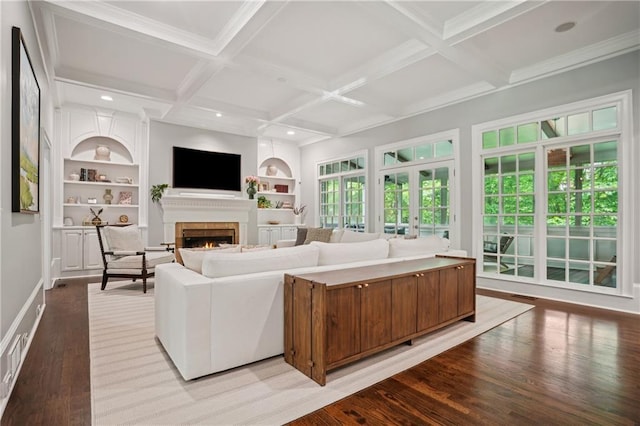4555 Peachtree Dunwoody Rd, Sandy Springs, GA 30342 - living area featuring built in features, beam ceiling, a lit fireplace, coffered ceiling, and light wood finished floors