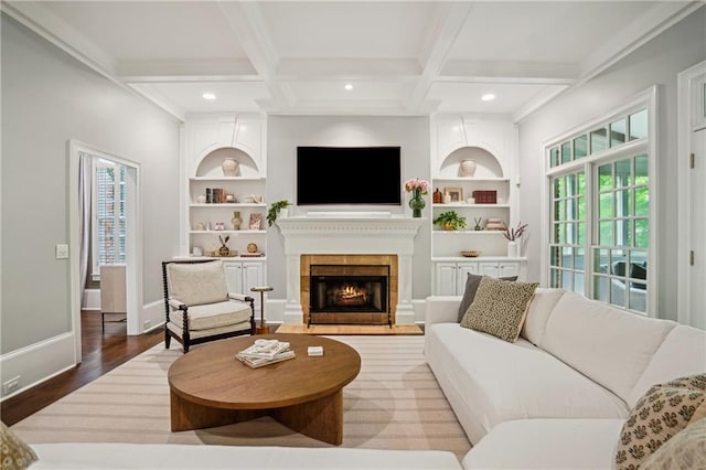 4555 Peachtree Dunwoody Rd, Sandy Springs, GA 30342 - living area featuring built in features, beam ceiling, wood finished floors, baseboards, and a warm lit fireplace