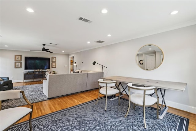 living area with recessed lighting, visible vents, and wood finished floors