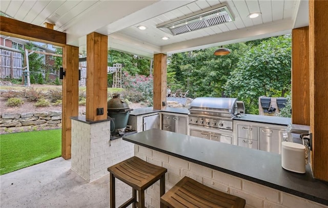 view of patio with area for grilling, visible vents, and grilling area