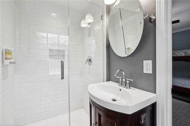 bathroom featuring vanity, a stall shower, ensuite bathroom, and ornamental molding