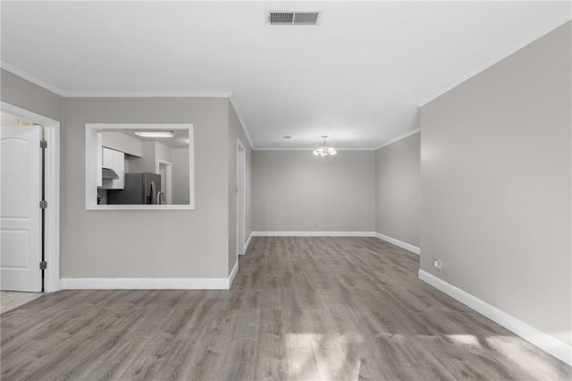 765 Houston Mill Rd NE Unit 7, Atlanta, GA 30329 - spare room featuring wood finished floors, a chandelier, baseboards, and ornamental molding