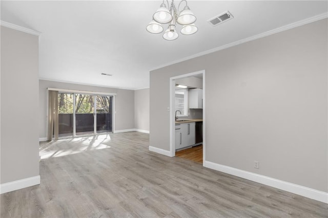 765 Houston Mill Rd NE Unit 7, Atlanta, GA 30329 - unfurnished living room with ornamental molding, a chandelier, baseboards, and light wood-style floors