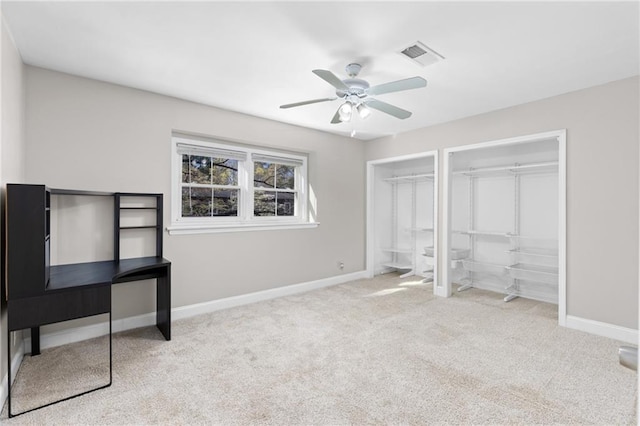 765 Houston Mill Rd NE Unit 7, Atlanta, GA 30329 - unfurnished bedroom with carpet floors, baseboards, multiple closets, and ceiling fan