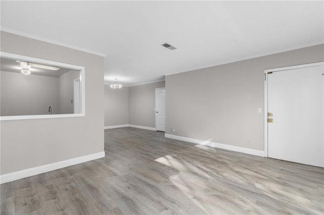 765 Houston Mill Rd NE Unit 7, Atlanta, GA 30329 - empty room with a chandelier, crown molding, wood finished floors, and baseboards
