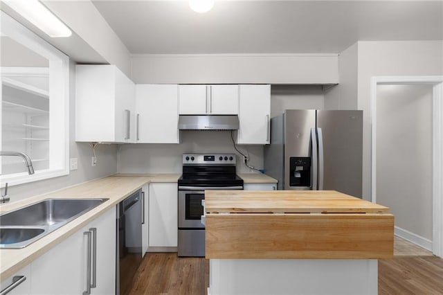 765 Houston Mill Rd NE Unit 7, Atlanta, GA 30329 - kitchen with appliances with stainless steel finishes, under cabinet range hood, wood counters, a sink, and a kitchen island