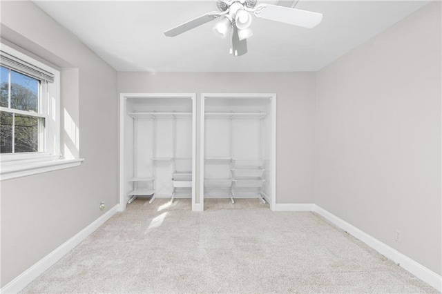 765 Houston Mill Rd NE Unit 7, Atlanta, GA 30329 - unfurnished bedroom featuring two closets, carpet flooring, baseboards, and ceiling fan