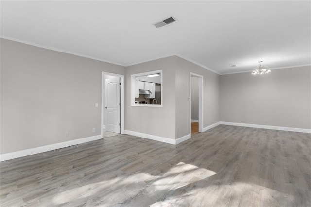 765 Houston Mill Rd NE Unit 7, Atlanta, GA 30329 - unfurnished room featuring a chandelier, wood finished floors, baseboards, and ornamental molding