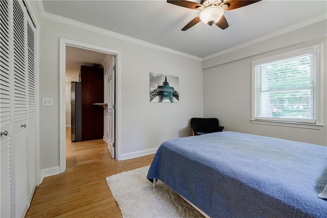 2985 Westbury Dr, Decatur, GA 30033 - bedroom with light wood-type flooring, ornamental molding, baseboards, a ceiling fan, and a closet