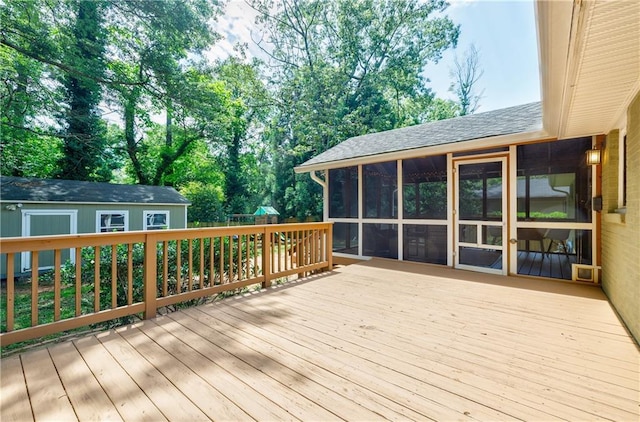 2985 Westbury Dr, Decatur, GA 30033 - wooden deck with a sunroom, an outdoor structure, and view of wooded area