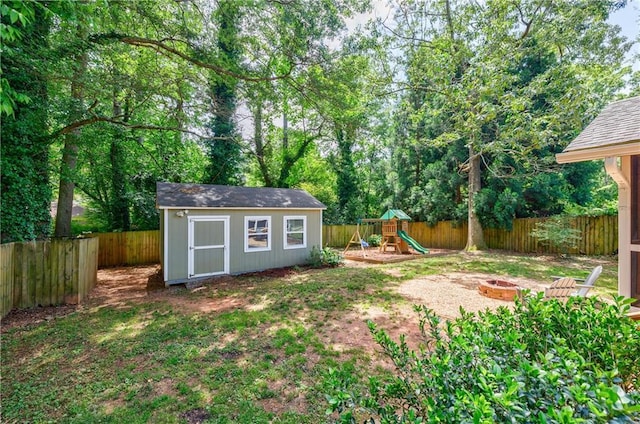 2985 Westbury Dr, Decatur, GA 30033 - fenced backyard with an outdoor fire pit, a playground, and an outbuilding