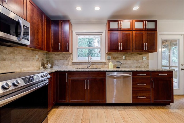 2985 Westbury Dr, Decatur, GA 30033 - kitchen featuring appliances with stainless steel finishes, a sink, light stone countertops, crown molding, and glass insert cabinets