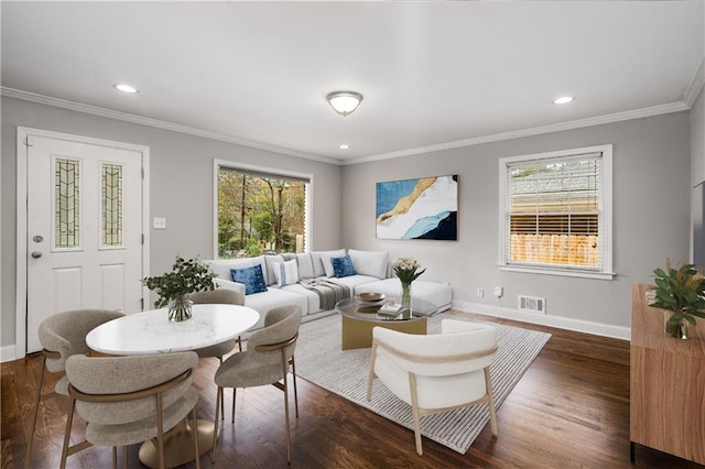 living room featuring crown molding, dark wood-type flooring, and a wealth of natural light