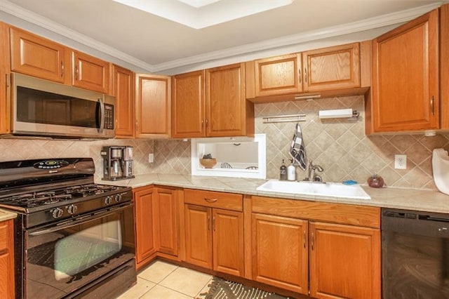 kitchen with light tile patterned floors, a sink, light countertops, backsplash, and black appliances