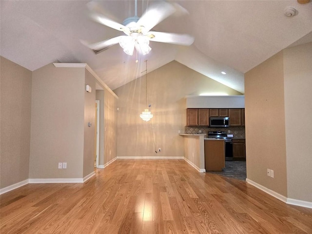 kitchen featuring lofted ceiling, stainless steel microwave, light wood-style floors, electric range, and ceiling fan