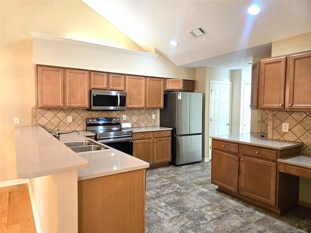 kitchen with a sink, stainless steel appliances, backsplash, a peninsula, and visible vents