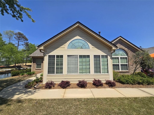 view of side of property with brick siding