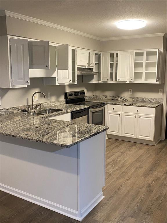 kitchen with dark stone countertops, sink, stainless steel electric range oven, and white cabinets