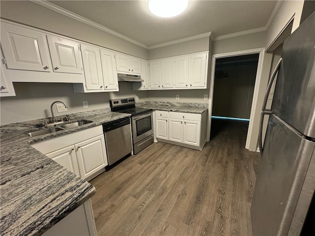 kitchen with dark stone counters, dark wood-type flooring, sink, white cabinetry, and stainless steel appliances