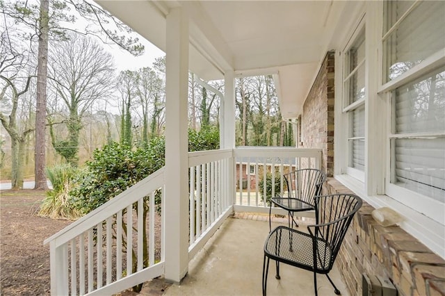 balcony featuring covered porch and a sunroom